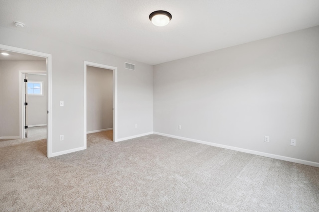 unfurnished bedroom with light colored carpet