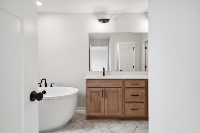 bathroom featuring vanity and a tub