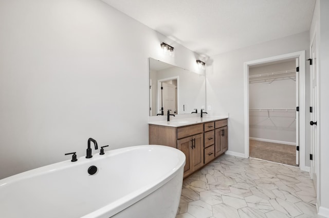 bathroom with a tub to relax in and vanity