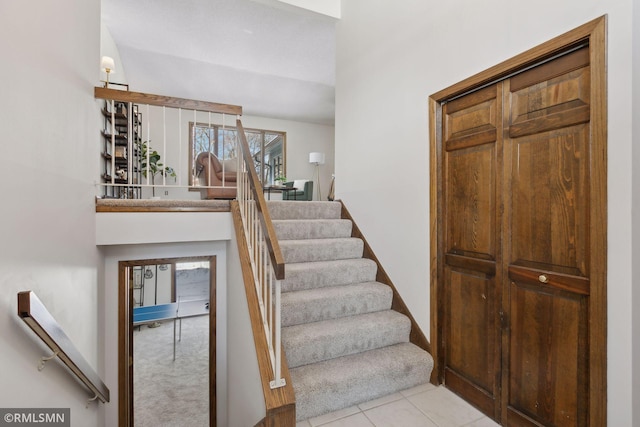 staircase featuring tile patterned floors