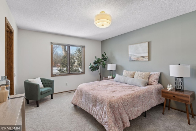 bedroom featuring a textured ceiling, carpet floors, and baseboards