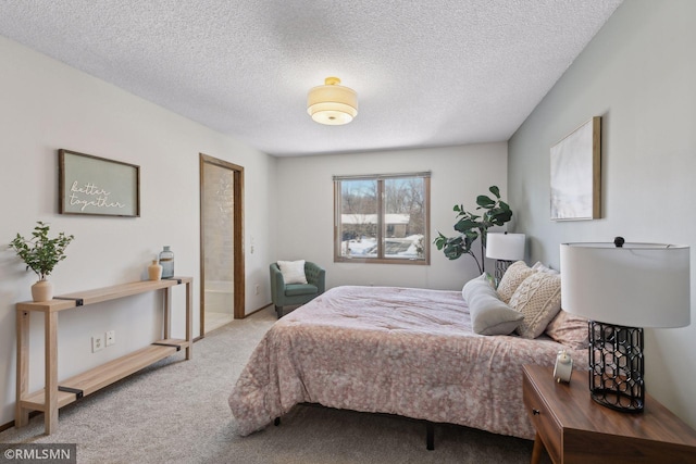 bedroom featuring light carpet and a textured ceiling