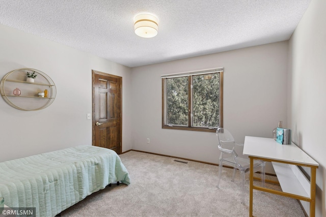 bedroom featuring light carpet, a textured ceiling, visible vents, and baseboards