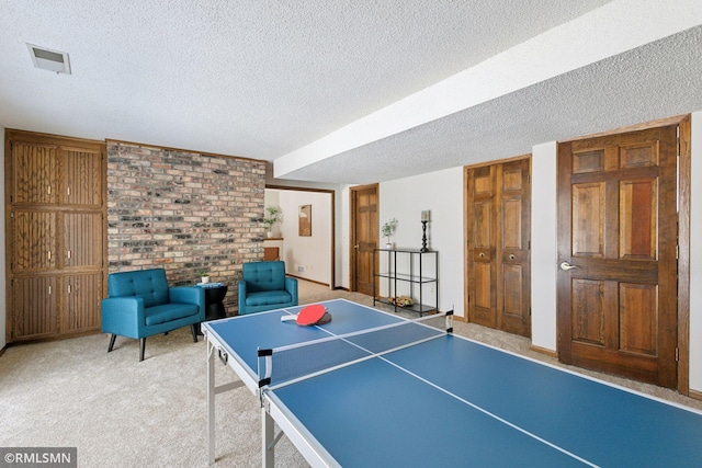 game room with visible vents, a textured ceiling, and carpet flooring