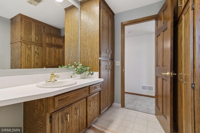 bathroom with tile patterned flooring, visible vents, vanity, and baseboards