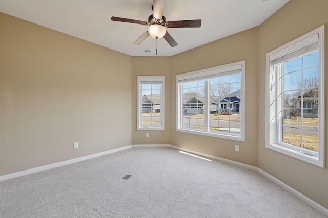 unfurnished room featuring baseboards, a ceiling fan, and carpet flooring