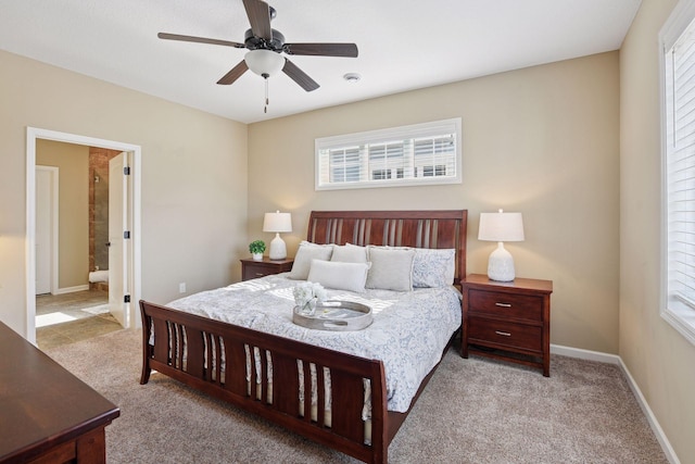 bedroom featuring ceiling fan, baseboards, carpet floors, and ensuite bath