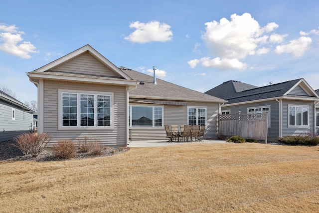 back of house featuring a patio and a yard