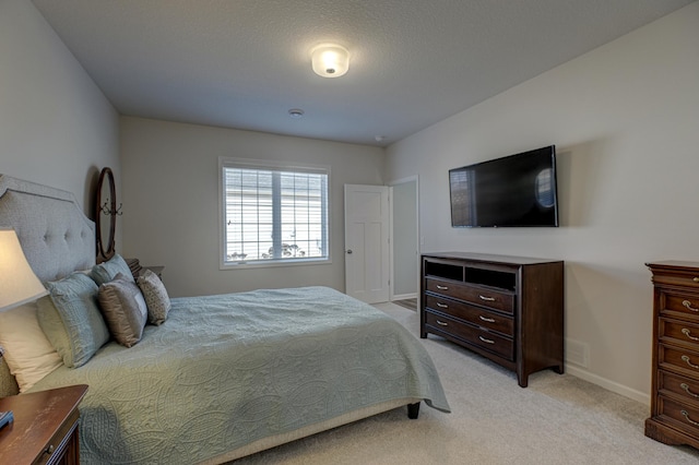 bedroom with light carpet, visible vents, and baseboards