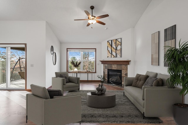 living room with hardwood / wood-style floors, a fireplace, ceiling fan, and vaulted ceiling