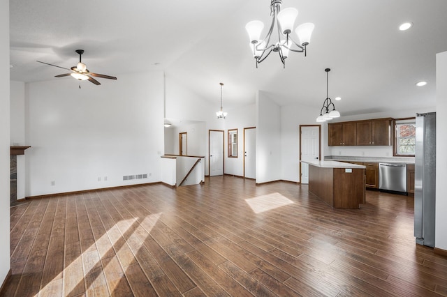 kitchen featuring a kitchen island, appliances with stainless steel finishes, dark hardwood / wood-style flooring, pendant lighting, and lofted ceiling