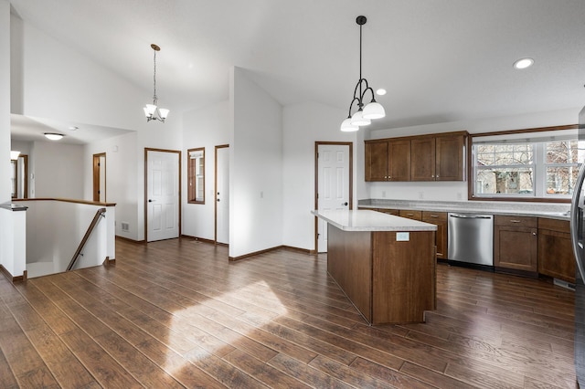 kitchen with stainless steel dishwasher, dark wood-type flooring, decorative light fixtures, and a center island