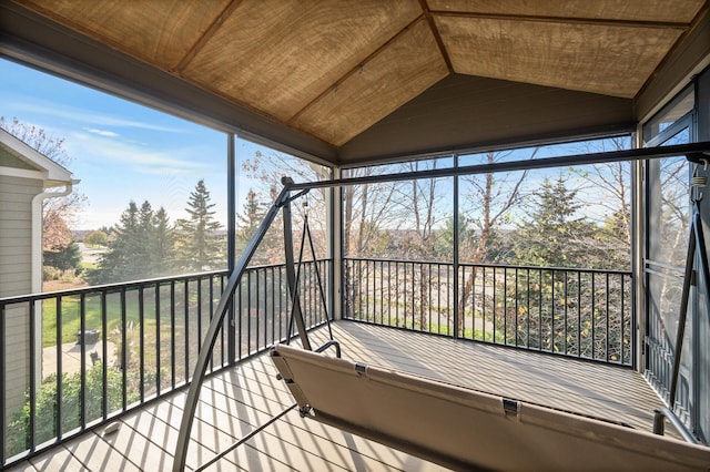 unfurnished sunroom featuring plenty of natural light, wood ceiling, and lofted ceiling