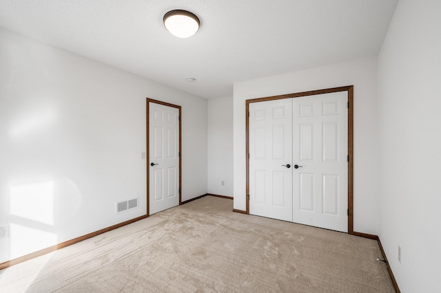 unfurnished bedroom with light colored carpet