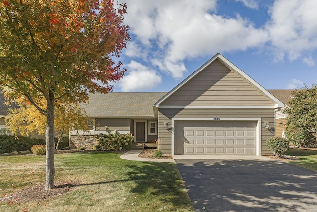 ranch-style home with a garage and a front yard