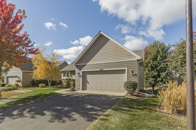 view of front of home featuring a garage and a front lawn