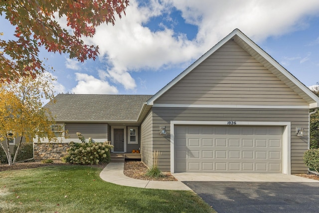 view of front of house with a garage and a front lawn