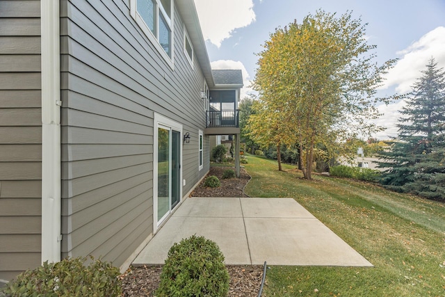 view of yard with a balcony and a patio area