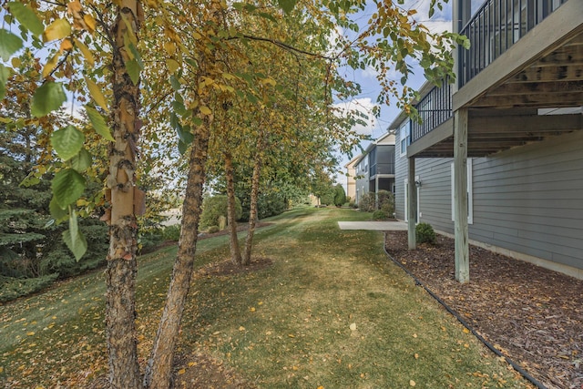 view of yard with a balcony