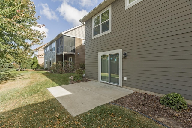 rear view of property with a patio and a yard