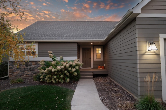 view of exterior entry at dusk