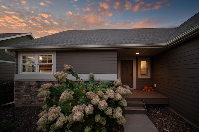 exterior entry at dusk with a deck