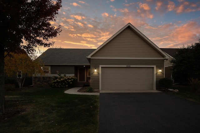 view of front of home featuring a garage and a lawn