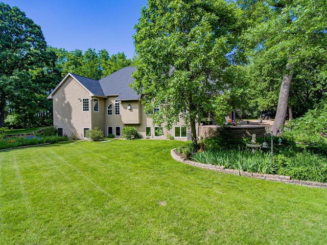 rear view of house with a lawn