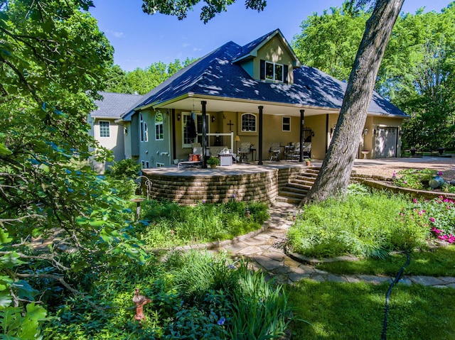 rear view of property with covered porch