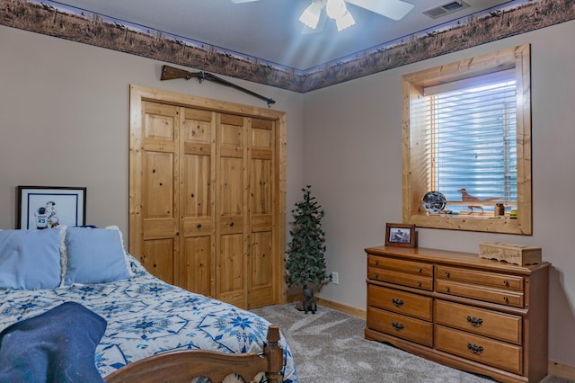 carpeted bedroom featuring a closet and ceiling fan