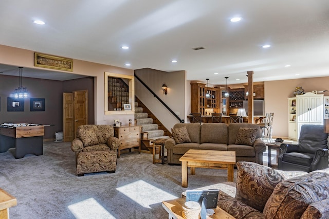 living room featuring a notable chandelier and carpet flooring