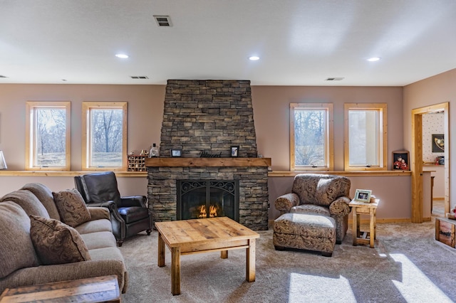 living room with a fireplace and carpet flooring