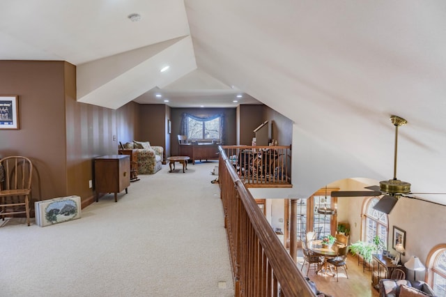 interior space with light colored carpet and lofted ceiling