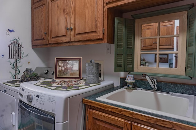 clothes washing area featuring cabinets, independent washer and dryer, and sink