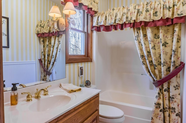 full bathroom featuring vanity, shower / tub combo, and toilet