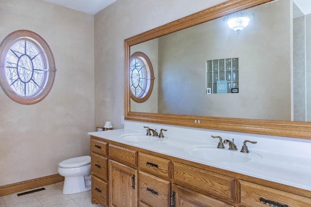 bathroom featuring vanity, toilet, and tile patterned floors