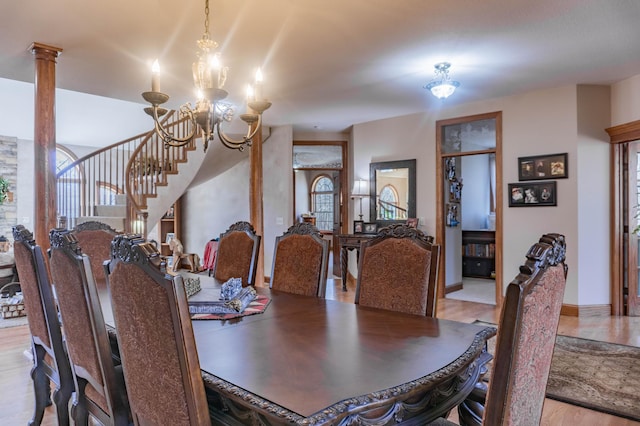 dining space with light hardwood / wood-style flooring, a chandelier, and a healthy amount of sunlight