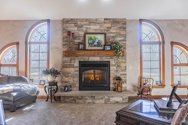 carpeted living room with a fireplace and plenty of natural light