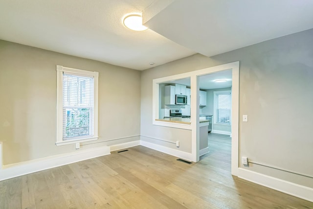 spare room featuring light hardwood / wood-style flooring