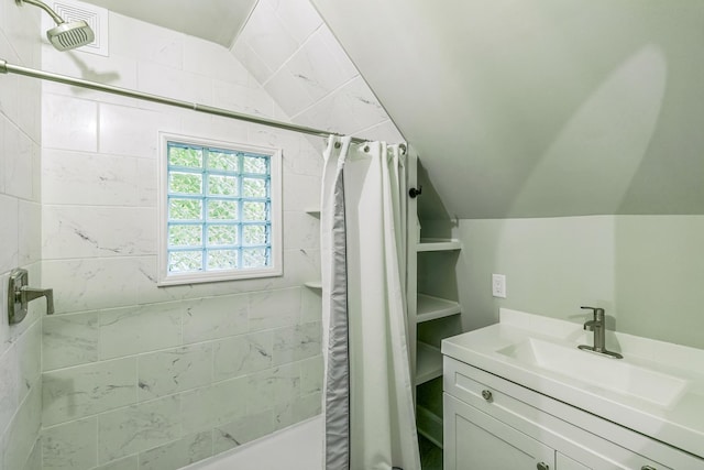 bathroom with vanity, vaulted ceiling, and a shower with shower curtain