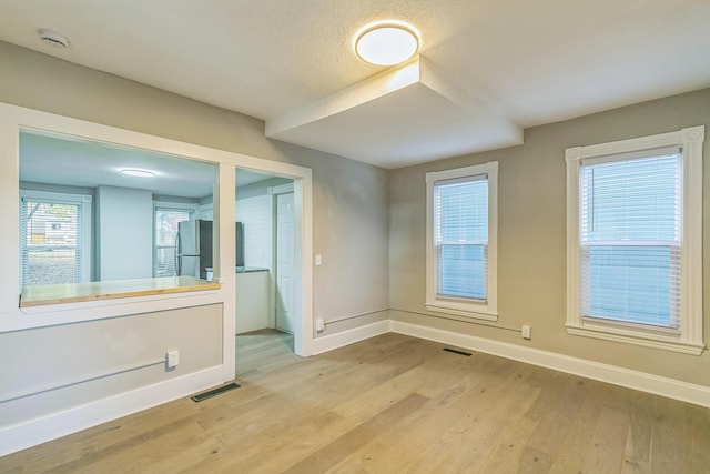 spare room with light wood-type flooring