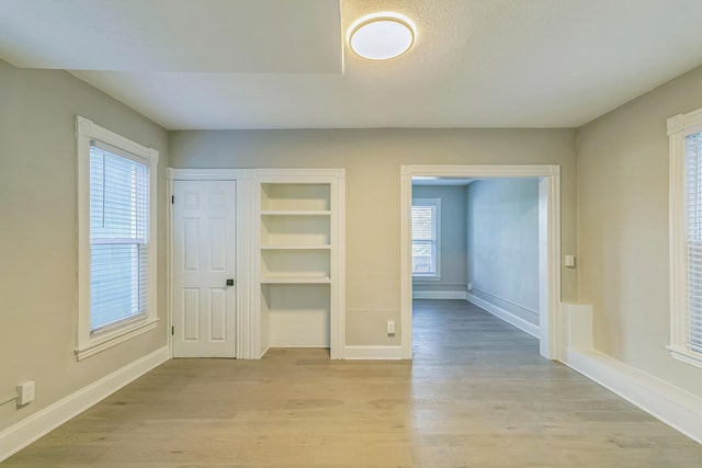 interior space featuring light wood-type flooring and a healthy amount of sunlight