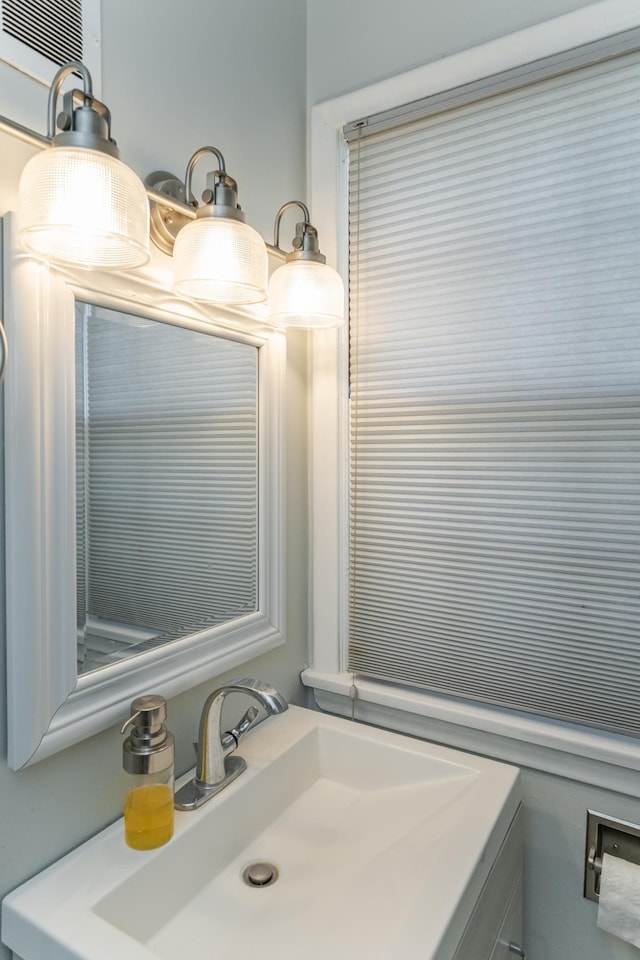 bathroom with a wall unit AC and vanity