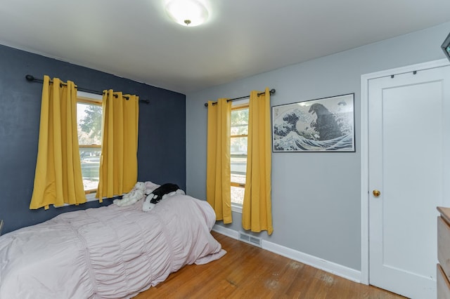 bedroom with wood-type flooring