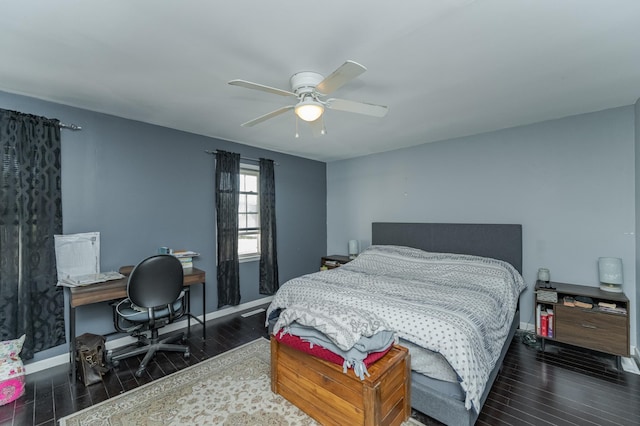 bedroom with ceiling fan and dark hardwood / wood-style flooring