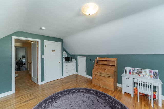 interior space with lofted ceiling and light wood-type flooring