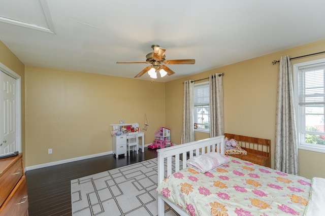 bedroom with ceiling fan and dark hardwood / wood-style floors