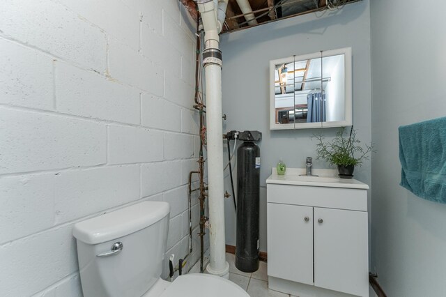 bathroom featuring tile patterned flooring, vanity, and toilet