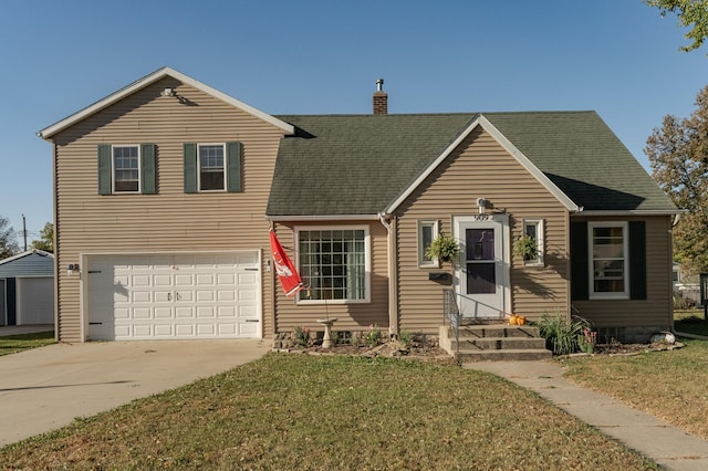 view of front of property featuring a front lawn and a garage