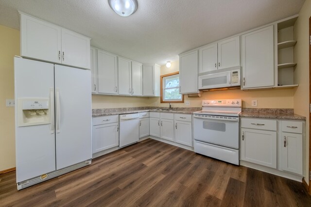 kitchen featuring white cabinets, a textured ceiling, white appliances, and dark wood-type flooring